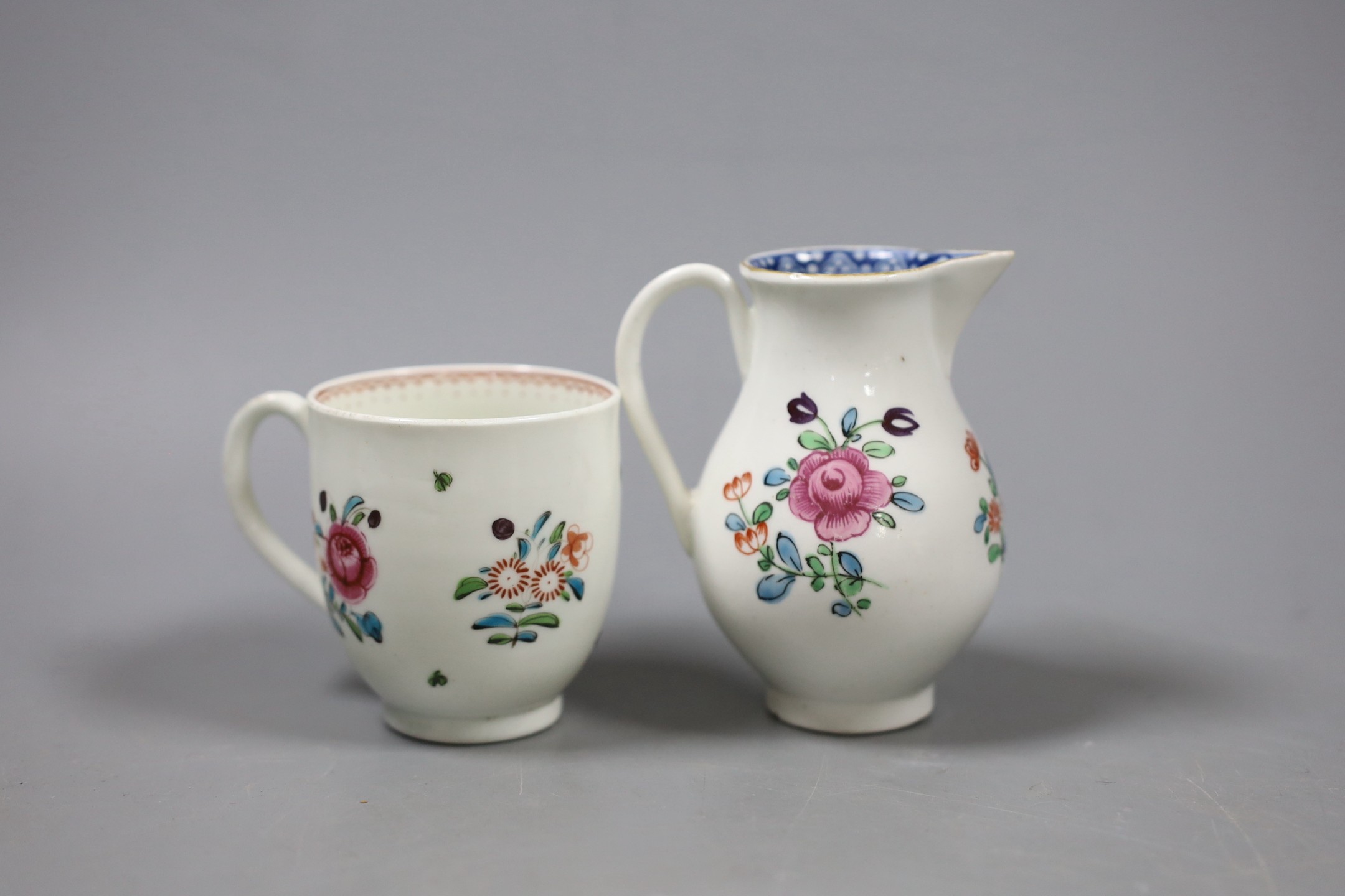 A Worcester sparrow beak jug, enamelled with flowers with an inner underglaze blue border and a similar coffee cup with a line loop and dot border. Tallest 9cm